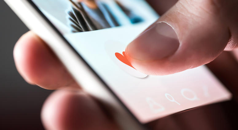 Man giving a like to photo on social media or swiping on online dating app. GrindrOnlineDatingApp