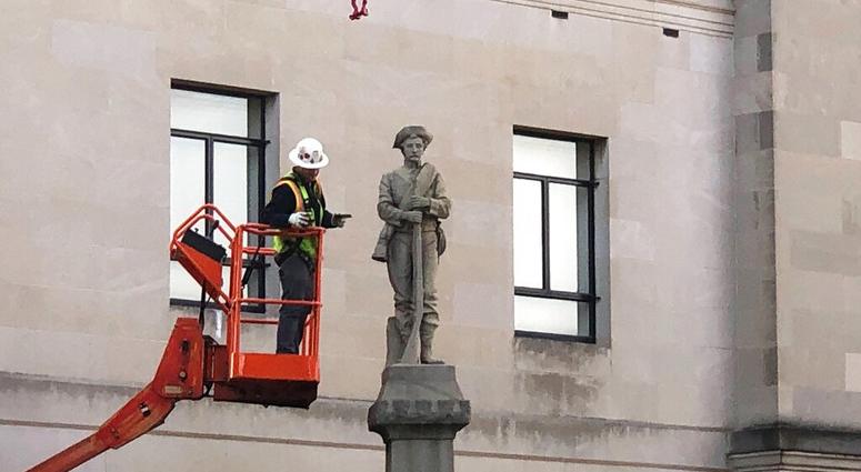 A workman prepares a Confederate staute for removal, Tuesday, March 12, 2019, in Winston-Salem, N.C. (AP Photo/Tom Foreman Jr.)