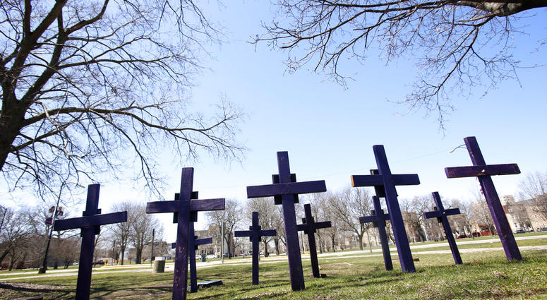 FILE - In this Thursday, April 19, 2018 file photo, crosses representing victims of gun violence stand outside Collins Academy High School in Chicago's North Lawndale neighborhood. With frustration mounting over lawmakers' inaction on gun control, the Ame