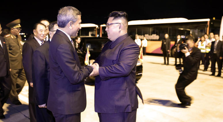 In this photo released by the Ministry of Communications and Information, Singapore, North Korean leader Kim Jong Un, center, is greeted before his departure, at Changi airport, following the summit with U.S. President Donald Trump, Tuesday, June 12, 2018