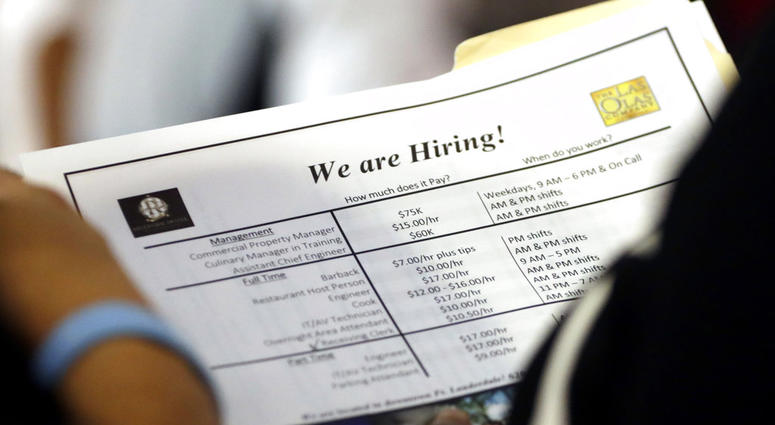 In this Thursday, June 21, 2018 photo, a job applicant looks at job listings for the Riverside Hotel at a job fair hosted by Job News South Florida, in Sunrise, Fla. The Labor Department said Friday, July 6, that the unemployment rate rose to 4.0 percent