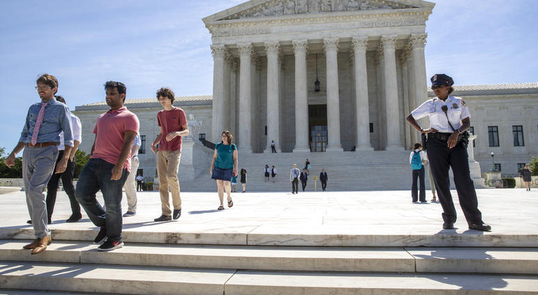 Visitors depart the Supreme Court early Monday, June 25, 2018. The justices are expected to hand down decisions this week as the court's term comes to a close. (AP Photo/J. Scott Applewhite)