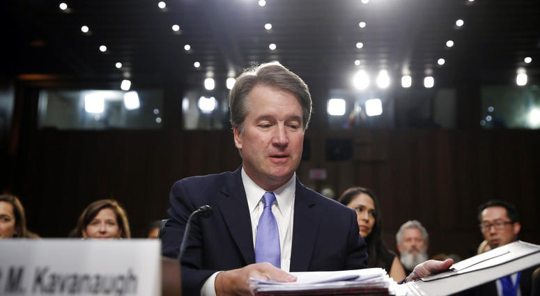 President Donald Trump's Supreme Court nominee, Brett Kavanaugh readies his papers before he testifies before the Senate Judiciary Committee on Capitol Hill. (AP Photo/Alex Brandon)