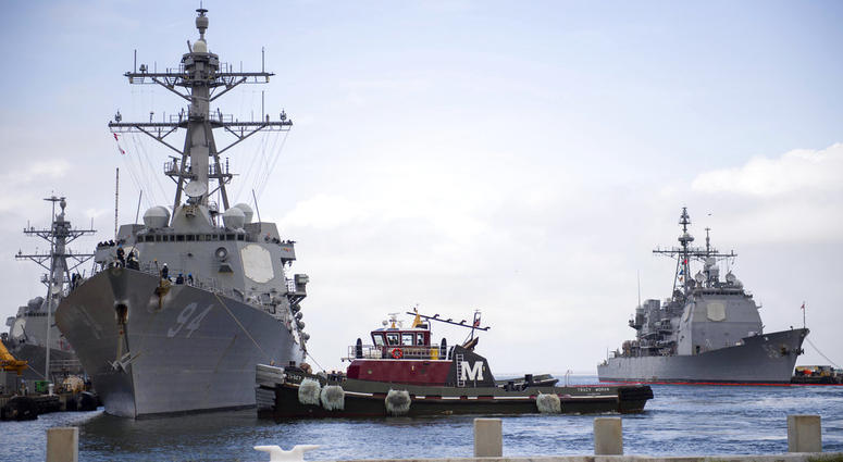 In this Monday, Sept. 10, 2018, photo released by the U.S. Navy, the guided-missile destroyer USS Nitze departs Naval Station Norfolk after the announcement of Hurricane Florence, in Norfolk, Va.