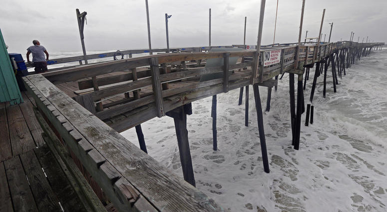 An onlooker checks out the heavy surf at the Avalon Fishing Pier in Kill Devil Hills, N.C., Thursday, Sept. 13, 2018 as Hurricane Florence approaches the east coast. (AP Photo/Gerry Broome) An onlooker checks out the heavy surf at the Avalon Fishing Pier in Kill Devil Hills, N.C., Thursday, Sept. 13, 2018 as Hurricane Florence approaches the east coast. (AP Photo/Gerry Broome)
