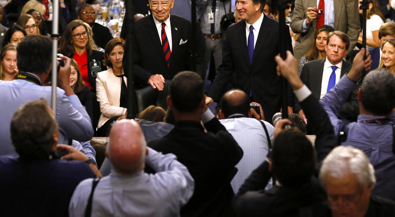 In this Sept. 4, 2018, file photo Supreme Court nominee Judge Brett Kavanaugh is surrounded by photographers as he stands with Senate Judiciary Committee Chairman Chuck Grassley R-Iowa