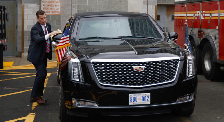 A Secret Service agent cleans the presidential limo before the arrival of Marine One carrying President Donald Trump at the Downtown Manhattan Heliport