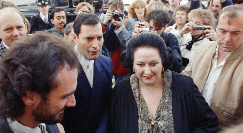 In this Monday, Oct. 10, 1988 file photo, rock star Freddie Mercury, center left, lead singer of the pop group Queen, arrives with opera star Montserrat Caballe at the Royal Albert Hall in London to publicize their hit song 'Barcelona.'