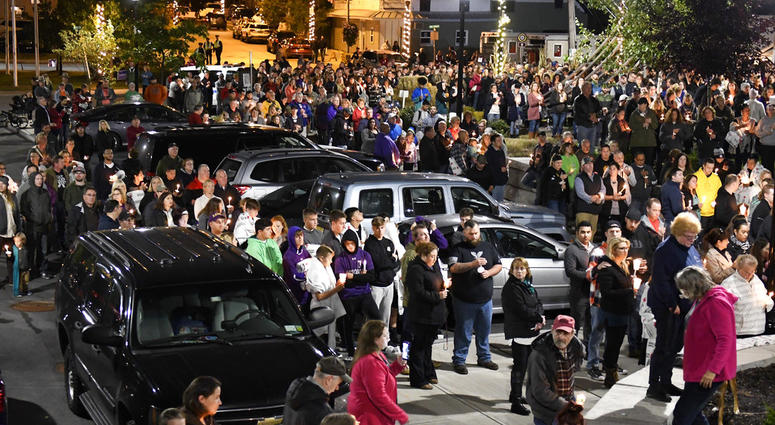 Family members and friends gather for a candlelight vigil memorial at Mohawk Valley Gateway Overlook Pedestrian Bridge in Amsterdam, N.Y., Monday, Oct. 8, 2018. The memorial honored 20 people who died in Saturday's fatal limousine crash in Schoharie, N.Y.