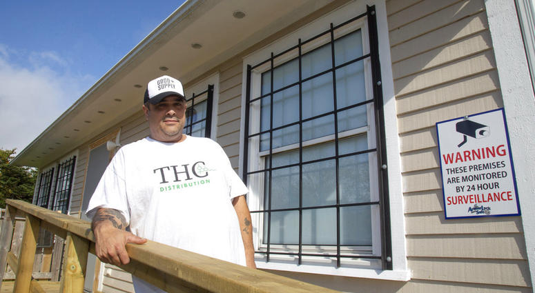 In this Oct. 4, 2018, file photo, Thomas Clarke poses for a photo outside his cannabis store, THC Distribution, in Portugal Cove-St. Philip's, Newfoundland and Labrador.