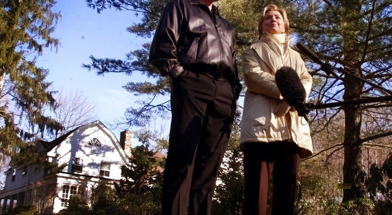 In this Jan. 6, 2000 file photo, Bill and Hillary Clinton stand in the driveway of their new home in Chappaqua, N.Y. (AP Photo, File)