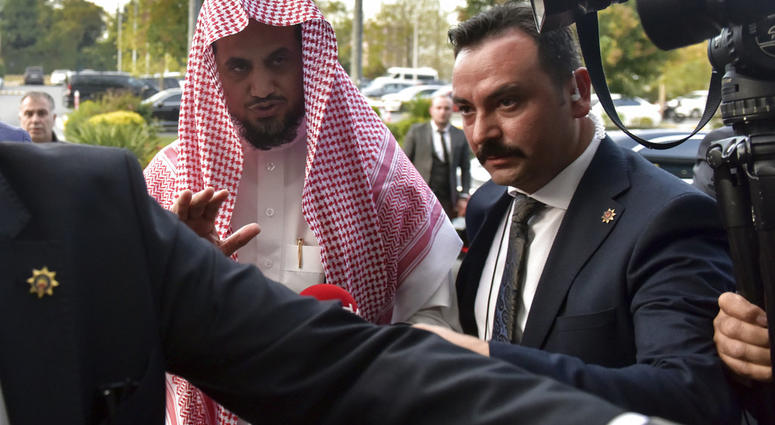Saudi Arabia's top prosecutor Saud al-Mojeb reacts to journalists as he boards a plane to leave Turkey, in Istanbul, Wednesday, Oct, 31, 2018. (DHA via AP)