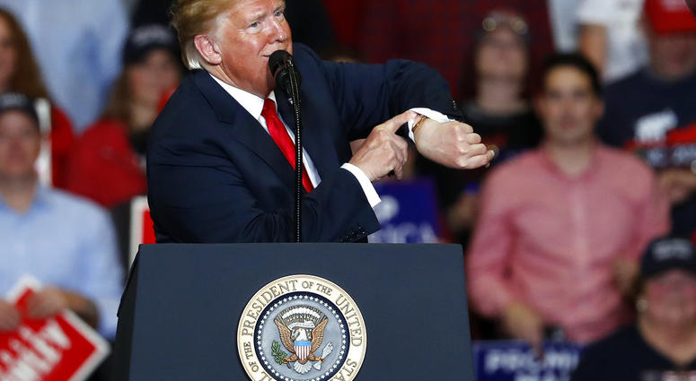 President Donald Trump looks at his watch near the end of a campaign rally Monday, Nov. 5, 2018, in Cape Girardeau, Mo. (AP Photo/Jeff Roberson)
