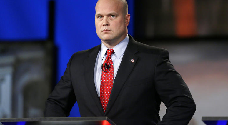 In this April 24, 2014, file photo, then-Iowa Republican senatorial candidate and former U.S. Attorney Matt Whitaker watches before a live televised debate in Johnston, Iowa. (AP Photo/Charlie Neibergall, File)