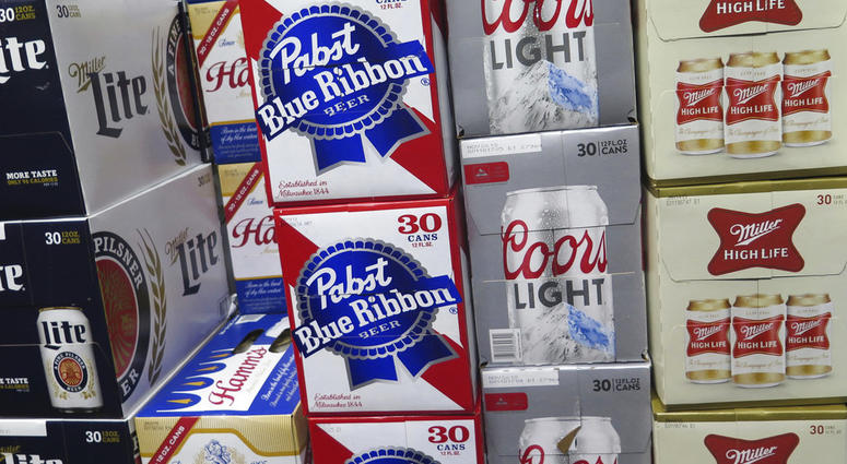 In this photo taken on Thursday, Nov. 8, 2018, cases of Pabst Blue Ribbon and Coors Light are stacked next to each other in a Milwaukee liquor store.