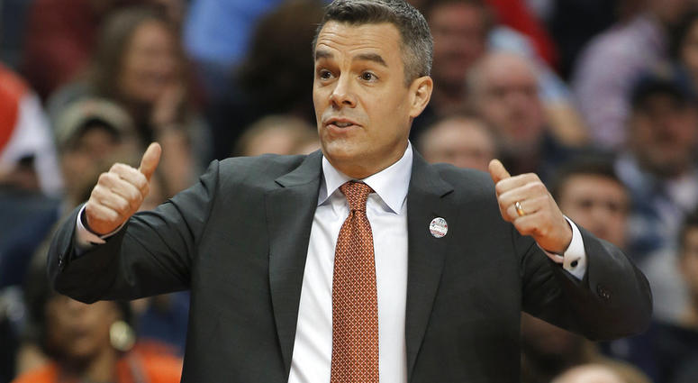 In this Friday, March 16, 2018 file photo, Virginia coach Tony Bennett signals for a jump ball