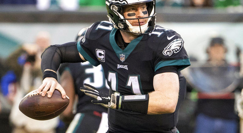 In this Nov. 25, 2018, file photo, Philadelphia Eagles quarterback Carson Wentz looks to pass
