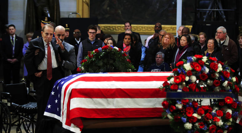 Bob Dole salutes casket of George H.W. Bush
