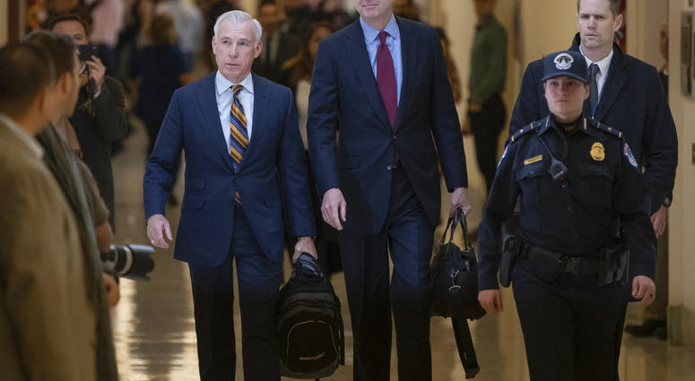 Former FBI Director James Comey, with his attorney, David Kelley, left, arrive to testify under subpoena behind closed doors before the House Judiciary and Oversight Committee in Washington, Friday, Dec. 7, 2018. (AP Photo/J. Scott Applewhite)