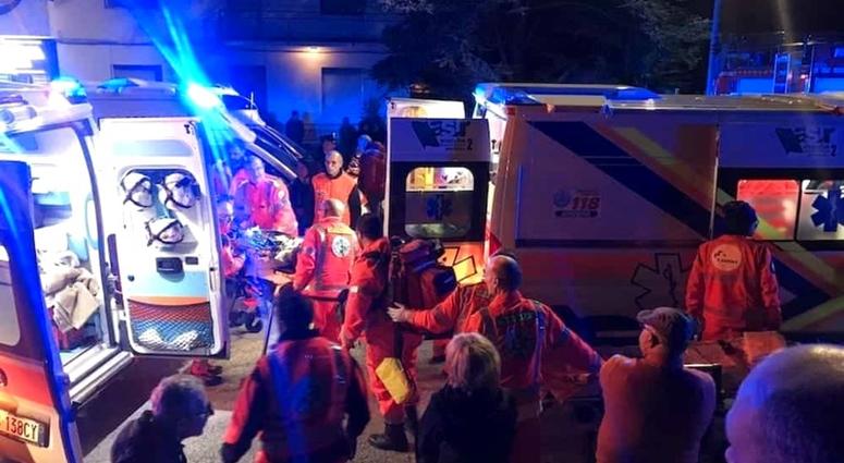Rescuers assist injured people outside a nightclub in Corinaldo, central Italy, early Saturday, Dec. 8, 2018.