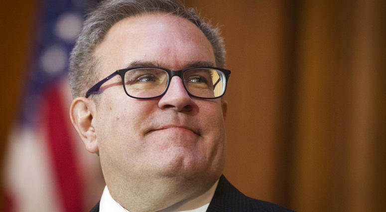Acting EPA Administrator Andrew Wheeler signs an order withdrawing federal protections for countless waterways and wetland, at EPA headquarters in Washington, Tuesday, Dec. 11, 2018.