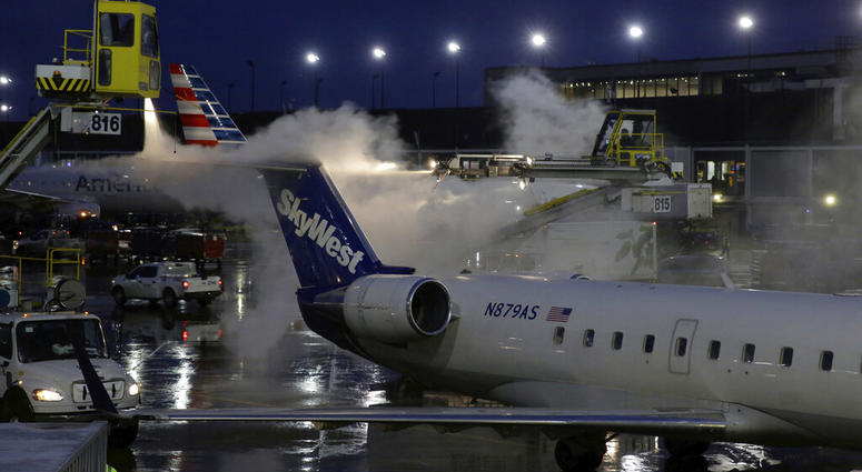 A deicing agent is applied to a SkyWest airplane before its takeoff, Friday, Jan. 18, 2019, at O'Hare International Airport in Chicago.