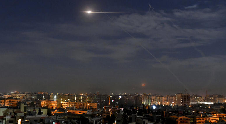 This photo released by the Syrian official news agency SANA, shows missiles flying into the sky near international airport, in Damascus, Syria, Monday, Jan. 21, 2019