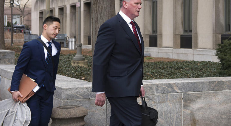 Kevin Downing, Paul Manafort's defense attorney, right, walks to the entrance of federal court on Wednesday, Feb. 13, 2019 in Washington. (AP Photo/Kevin Wolf)