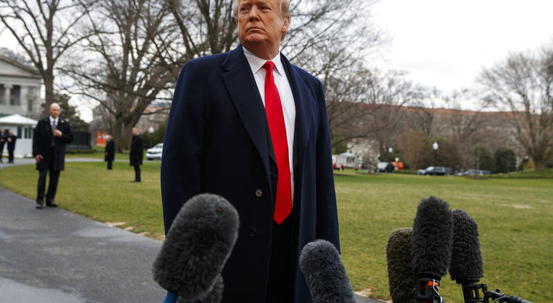 President Donald Trump listens to a question as he speaks with reporters before boarding Marine One on the South Lawn of the White House, Friday, March 22, 2019, in Washington. (AP Photo/Evan Vucci)
