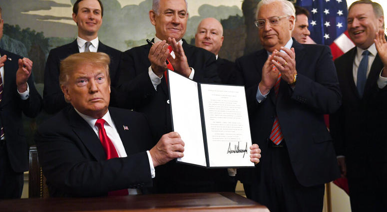 President Donald Trump holds up a signed proclamation recognizing Israel's sovereignty over the Golan Heights. (AP Photo/Susan Walsh) President Donald Trump holds up a signed proclamation recognizing Israel's sovereignty over the Golan Heights. (AP Photo/Susan Walsh)