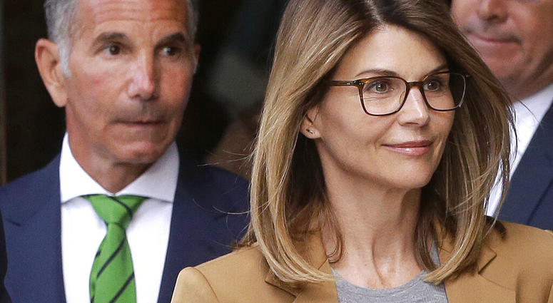 In this April 3, 2019 file photo, actress Lori Loughlin, front, and husband, clothing designer Mossimo Giannulli, left, depart federal court in Boston after facing charges in a nationwide college admissions bribery scandal. (AP Photo/Steven Senne, File)