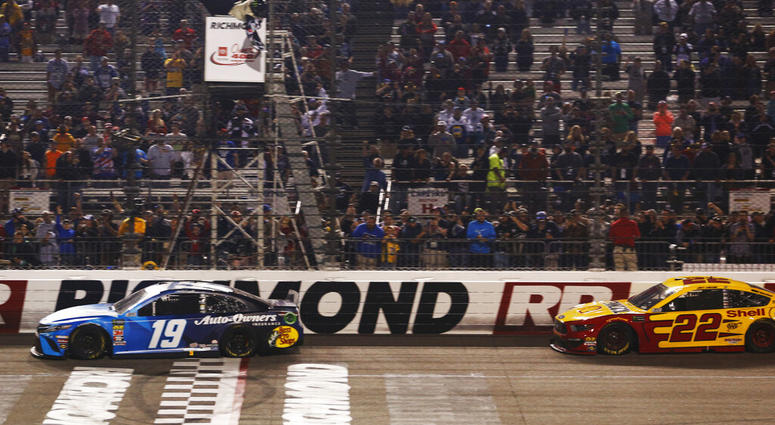 Martin Truex Jr. (19) crosses the finish line in front of Joey Logano (22) to win the NASCAR Cup Series auto race at Richmond Raceway in Richmond, Va., Saturday, April 13, 2019. (AP Photo/Steve Helber) Martin Truex Jr. (19) crosses the finish line in front of Joey Logano (22) to win the NASCAR Cup Series auto race at Richmond Raceway in Richmond, Va., Saturday, April 13, 2019. (AP Photo/Steve Helber)