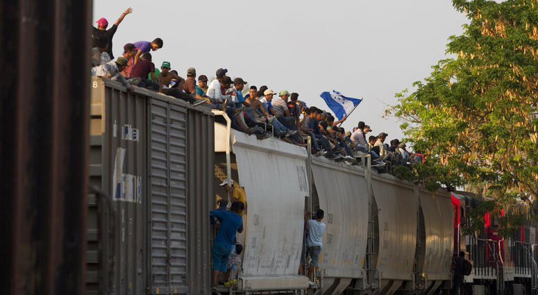 Central American migrants ride atop a freight train during their journey toward the U.S.-Mexico border, in Ixtepec, Oaxaca State, Mexico, Tuesday, April 23, 2019. (AP Photo/Moises Castillo)