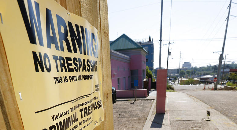 A "No Trespassing" sign is posted along the fencing protecting the parking lot of the Jackson Women's Health Organization, Friday, May 17, 2019, in Jackson, Miss. The facility is the state's only abortion clinic.(AP Photo/Rogelio V. Solis)