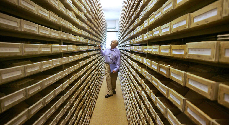 -FILE- In this May 8, 2008 file picture Gary Mokotoff, a Jewish genealogist from New Jersey, takes a look at name registers at the International Tracing Service in Bad Arolsen, central Germany. (AP Photo/Michael Probst, file) -FILE- In this May 8, 2008 file picture Gary Mokotoff, a Jewish genealogist from New Jersey, takes a look at name registers at the International Tracing Service in Bad Arolsen, central Germany. (AP Photo/Michael Probst, file)