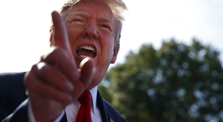 President Donald Trump talks with reporters before departing on Marine One for the Air Force Academy graduation ceremony, Thursday, May 30, 2019, in Washington. (AP Photo/Evan Vucci)