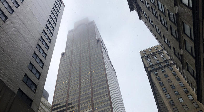 Mist and smoke cover the top of a building near 51st Street and 7th Avenue Monday, June 10, 2019, in New York, where a helicopter was reported to have crash landed on top of the roof of a building in midtown Manhattan. (AP Photo/Mark Lennihan)