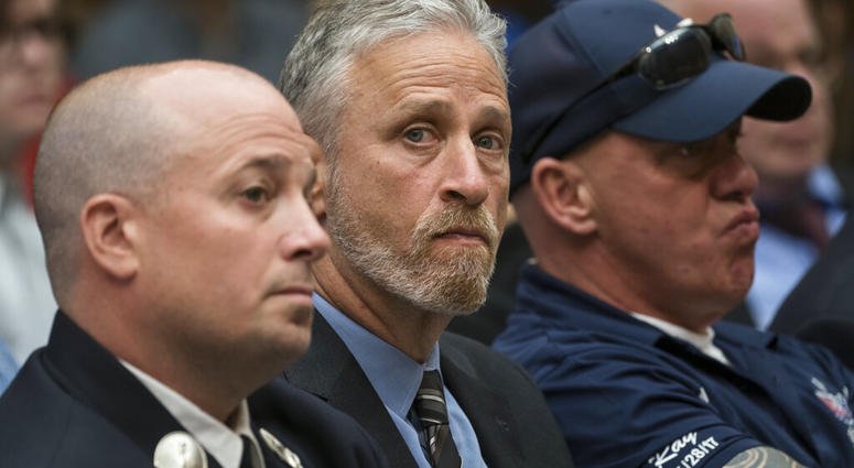 Entertainer and activist Jon Stewart lends his support to firefighters, first responders and survivors of the September 11 terror attacks at a hearing by the House Judiciary Committee. (AP Photo/J. Scott Applewhite) Entertainer and activist Jon Stewart lends his support to firefighters, first responders and survivors of the September 11 terror attacks at a hearing by the House Judiciary Committee. (AP Photo/J. Scott Applewhite)