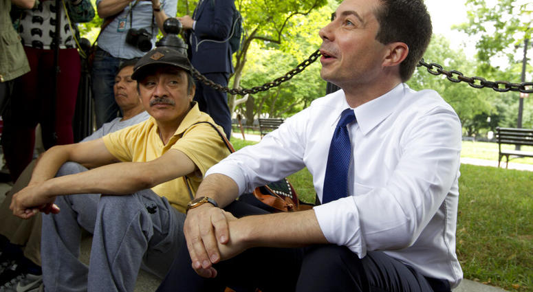 Democratic presidential candidate Mayor Pete Buttigieg, right, attends a rally protesting against President Donald Trump policies outside of the White House in Washington, Wednesday, June 12, 2019. (AP Photo/Jose Luis Magana)