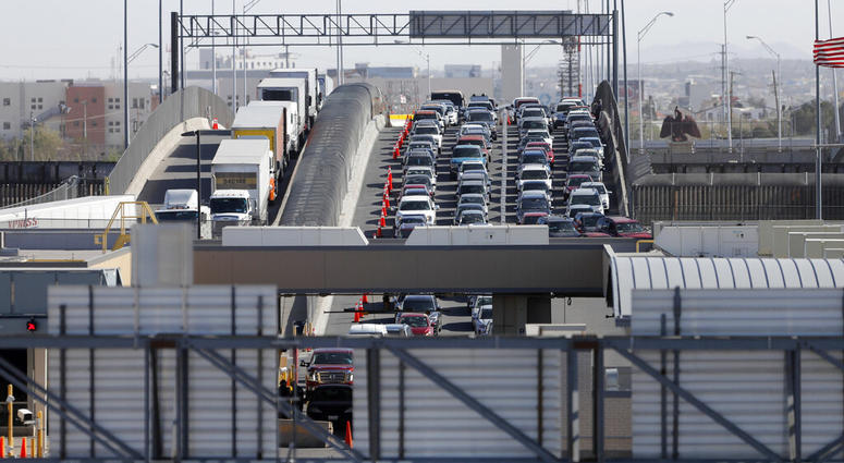 FILE - In this March 29, 2019, file photo, cars and trucks line up to enter the U.S. from Mexico at a border crossing in El Paso, Texas. Authorities in far South Texas say U.S. Border Patrol agents have discovered the bodies of four people, including thre