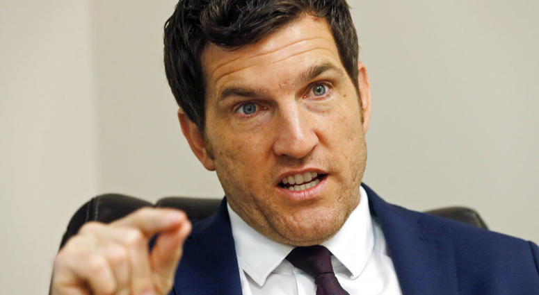 FILE - In this Friday, Oct. 7, 2016, file photo, then Virginia's 2nd District Congressman Scott Taylor speaks during an interview in his campaign office in Virginia Beach, Va. Taylor says he’s running for U.S. Senate in Virginia, hoping to unseat Democrat