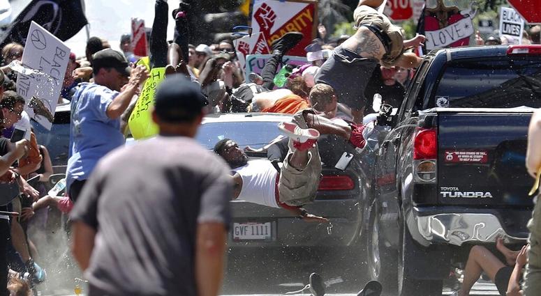 FILE - In this Aug. 12, 2017, file photo, people fly into the air as a vehicle is driven into a group of protesters demonstrating against a white nationalist rally in Charlottesville, Va. James Alex Fields Jr. Fields, who was sentenced to to life in priso