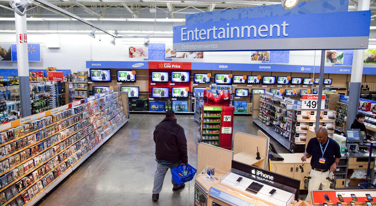 FILE = In this Dec. 15, 2010 file photo, a view of the entertainment section of a Wal-Mart store is seen in Alexandria, Va. Walmart is taking down all signs and displays from its stores that depict violence, following a mass shooting at its El Paso, Texas