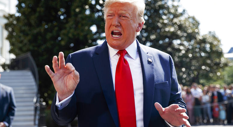 President Donald Trump talks to reporters on the South Lawn of the White House, Friday, Aug. 9, 2019, in Washington, as he prepares to leave Washington for his annual August holiday at his New Jersey golf club. (AP Photo/Evan Vucci)