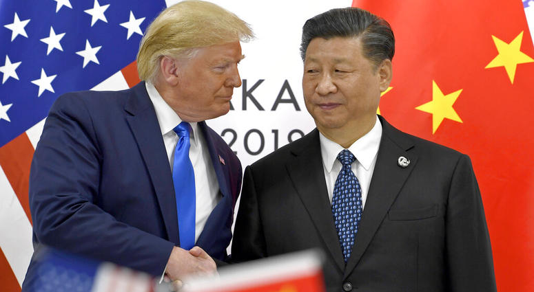 FILE - In this June 29, 2019, file photo, U.S. President Donald Trump, left, shakes hands with Chinese President Xi Jinping during a meeting on the sidelines of the G-20 summit in Osaka,