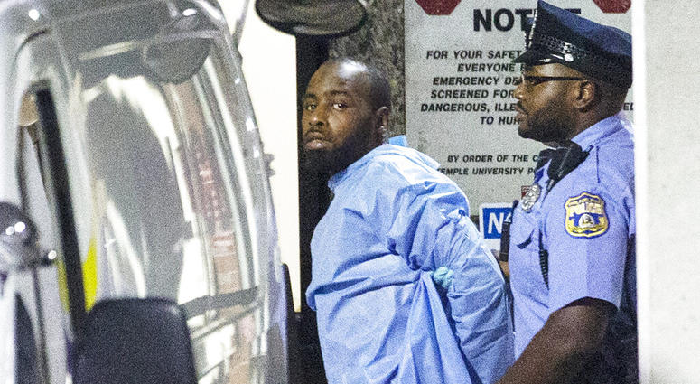 Police take shooting suspect, Maurice Hill, into custody after an hourslong standoff with police, that wounded several police officers, in Philadelphia early Thursday, Aug. 15, 2019. (Elizabeth Robertson/The Philadelphia Inquirer via AP)