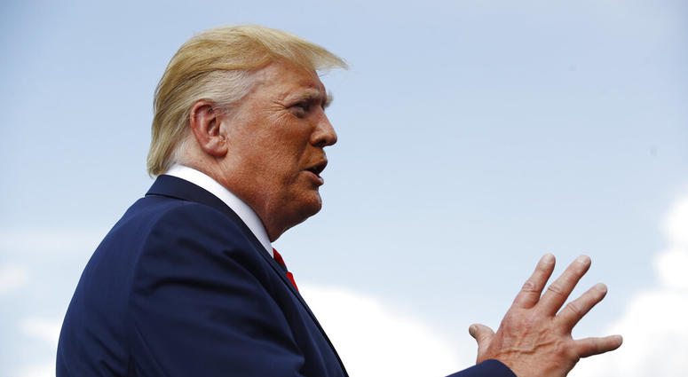 President Donald Trump speaks with reporters before boarding Air Force One at Morristown Municipal Airport in Morristown, N.J., Sunday, Aug. 18, 2019. (AP Photo/Patrick Semansky)