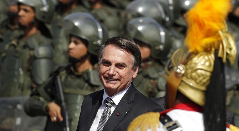 Brazils President Jair Bolsonaro arrive to attend a military ceremony for the Day of the Soldier, at Army Headquarters in Brasilia, Brazil, Friday, Aug. 23, 2019. Bolsonaro says he's leaning toward sending the army to help fight Amazon fires that have ala