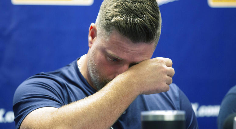 Montgomery Biscuits manager Morgan Ensberg wipes away tears during a news conference about pitcher Blake Bivens' wife and child who were killed in a triple homicide, Thursday, Aug. 29, 2019. (Kirsten Fiscus/Montgomery Advertiser via AP)