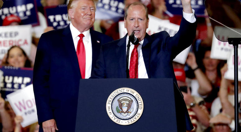 President Donald Trump, left, gives his support to Dan Bishop, right, a Republican running for the special North Carolina 9th District U.S. Congressional race as he speaks at a rally in Fayetteville, N.C., Monday, Sept. 9, 2019. (AP Photo/Chris Seward)